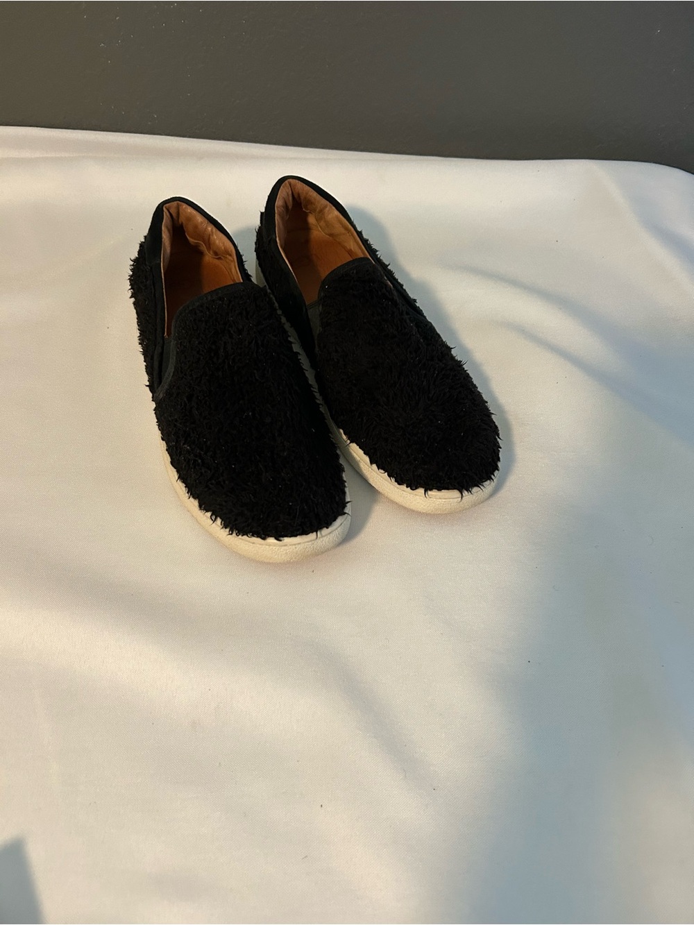 UGG Women's Black Fuzzy Slip-On Sneakers with White Sole